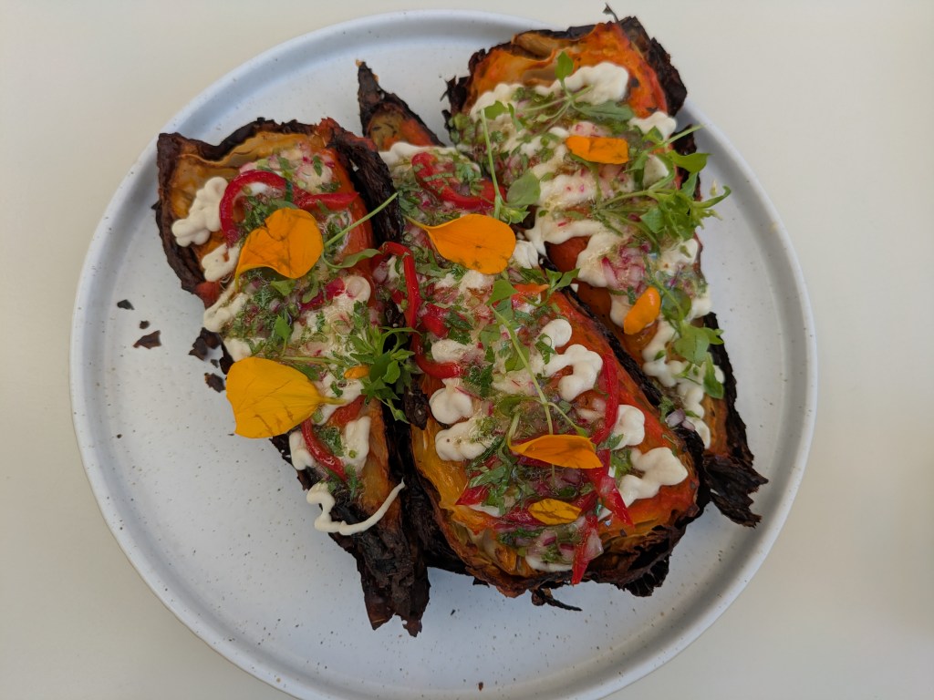 Three segments of charred cabbage, nicely dressed
