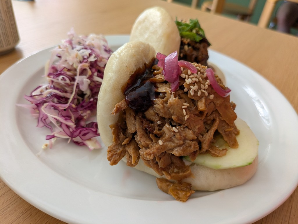 A fluffy bao bun filled with mock duck