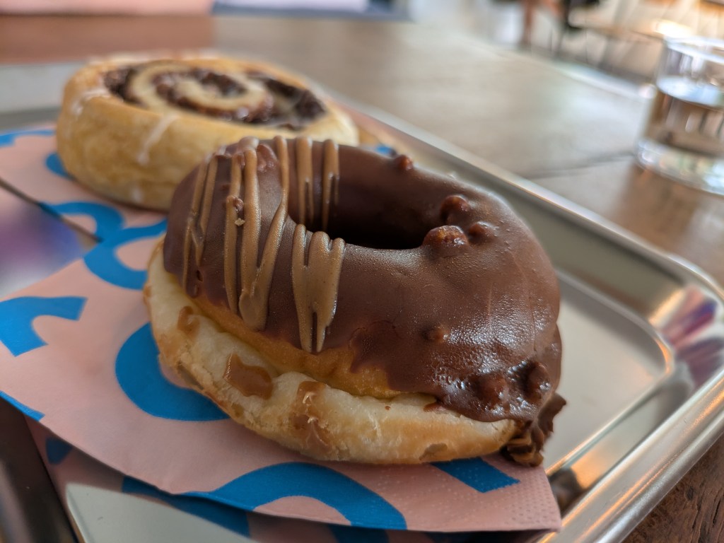 A ring doughnut topped with chocolate