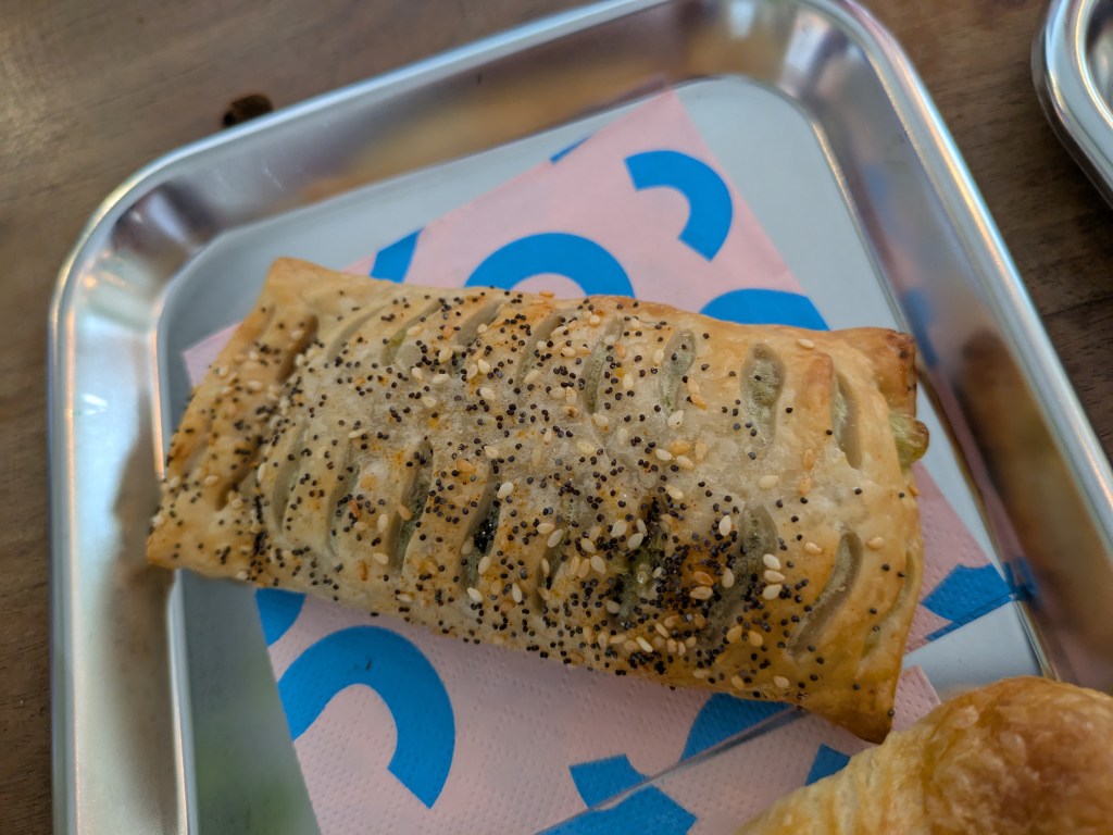 A thin rectangular pastry topped with seeds
