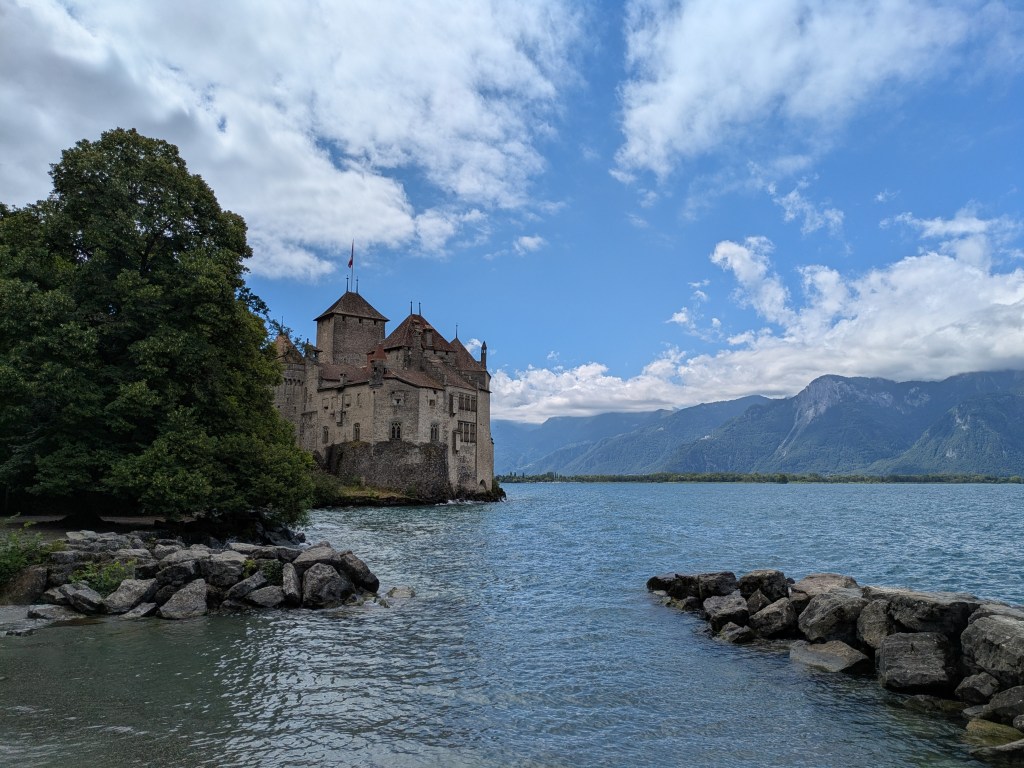 A castle on the lake at Montreux, with mountains in the background