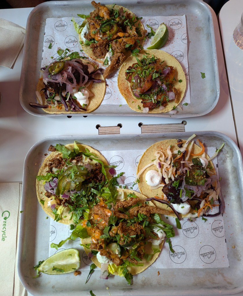Two trays each containing three tacos