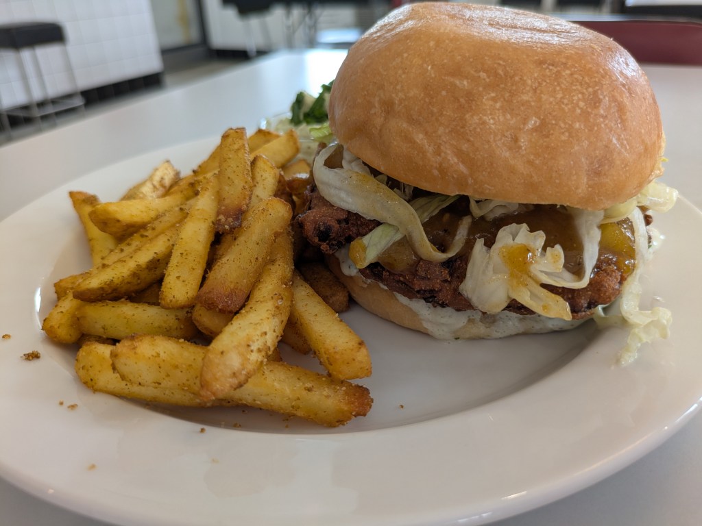A burger with chips dusted with spices