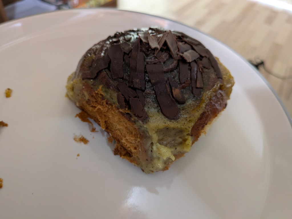 A big custardy cinnamon roll topped with chocolate