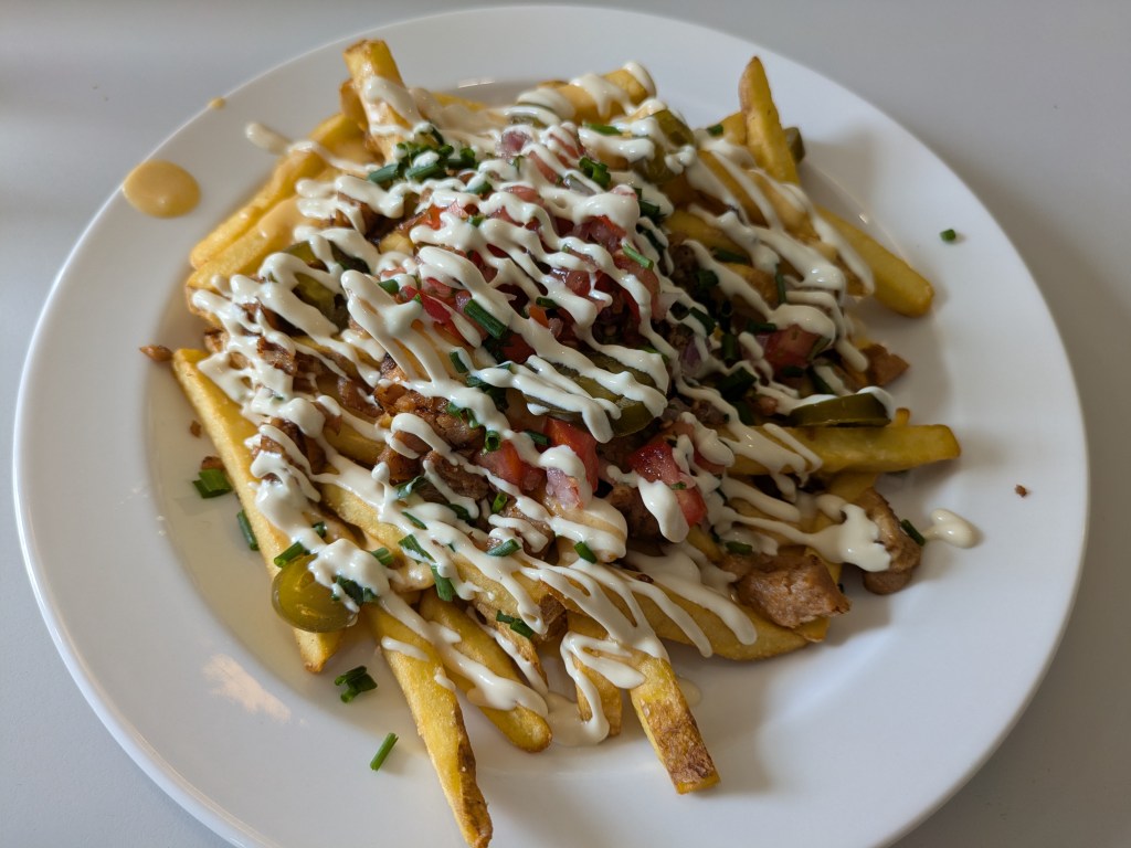 A big plate of chips with lots of toppings