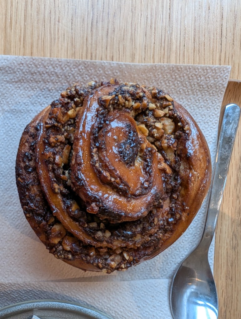 A babka roll with a sticky, nutty topping