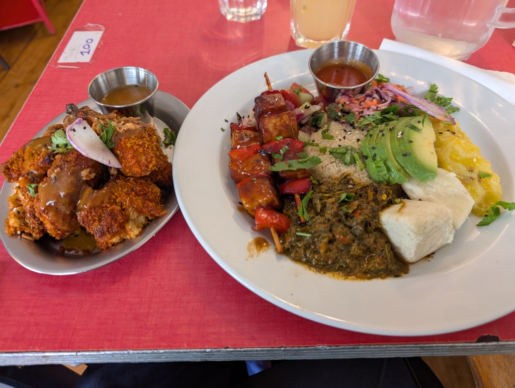 A plate of cauliflower wings and a mixed plate with loads of different things on it 