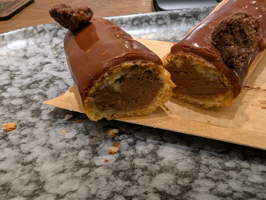 An eclair filled with chocolate cream and topped with chocolate 