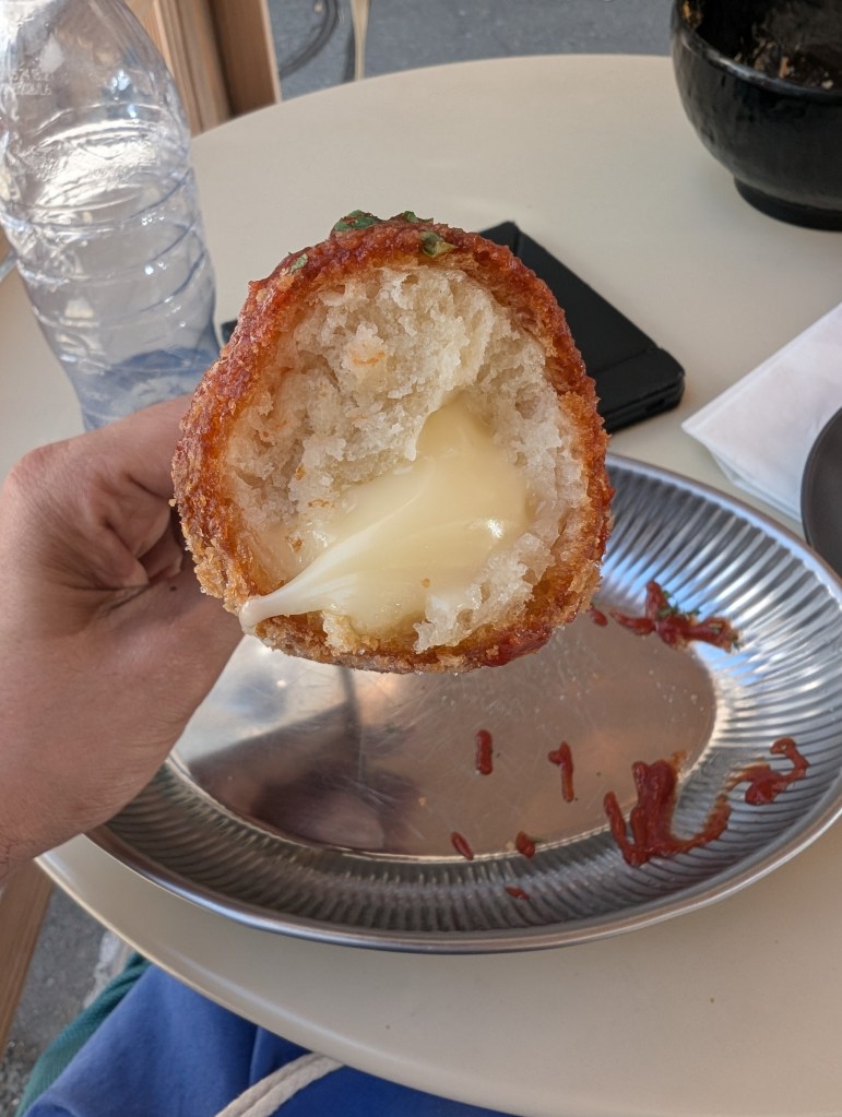 The inside of the corn dog, filled with melted cheese