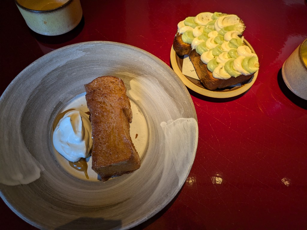 Two sweet dishes - a French toast and a slice of decorated brioche
