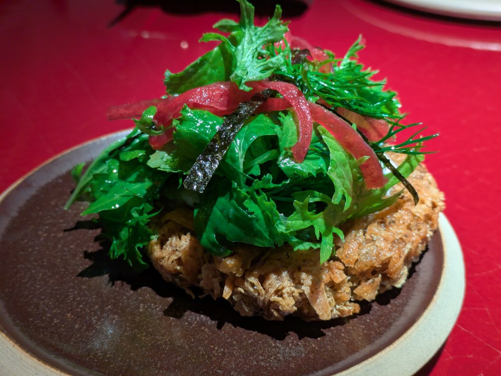 A rösti topped with salad