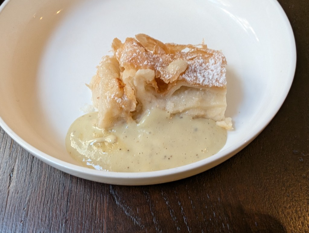 A flaky looking strudel with custard flecked with vanilla 