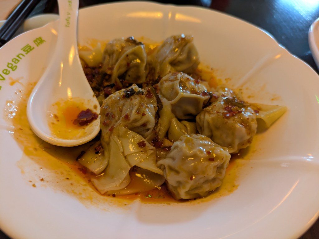 A dish of filled wontons in sauce