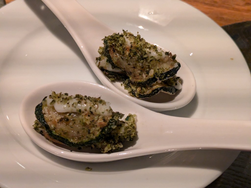 Two spoons with slices of fried courgette and cream