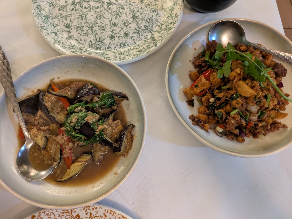 Two dishes of Thai food with vegetables, mock meat and herbs