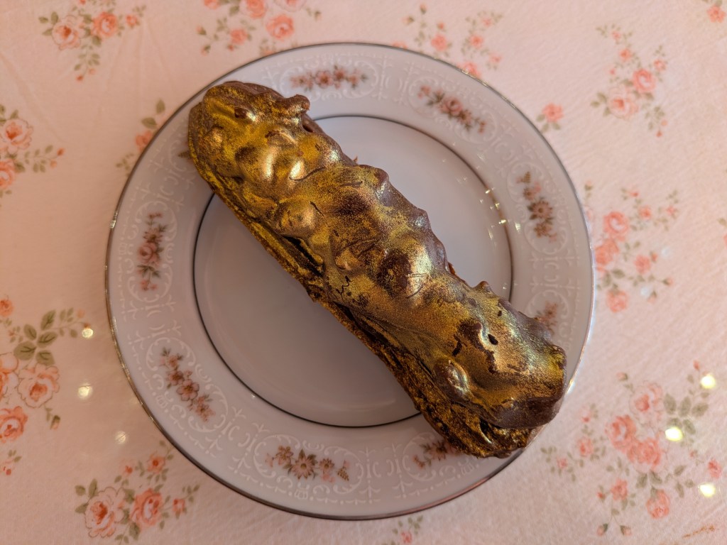 A chocolate eclair dusted with good
