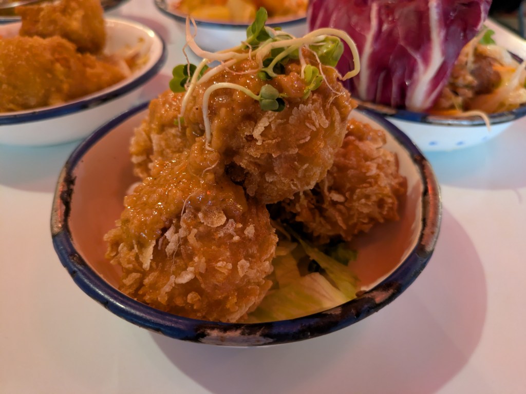 Four crispy coated balls with peanut sauce