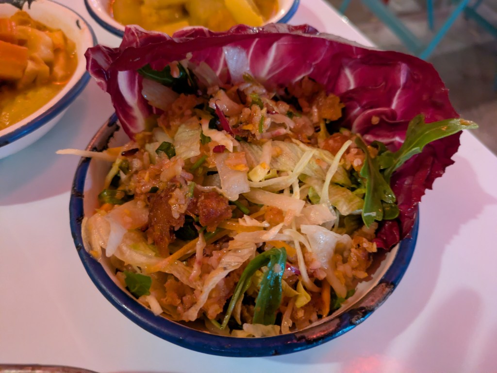 A red cabbage leaf filled with crispy salad