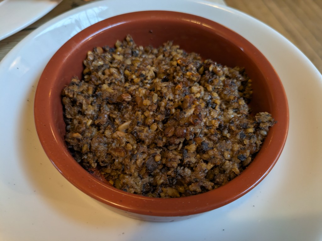 A small bowl filled with a crumbly lentil dish