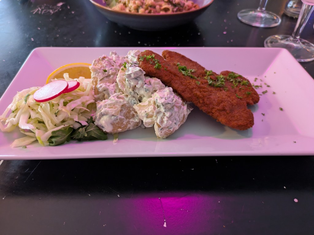 A schnitzel, potato salad, and side salad 