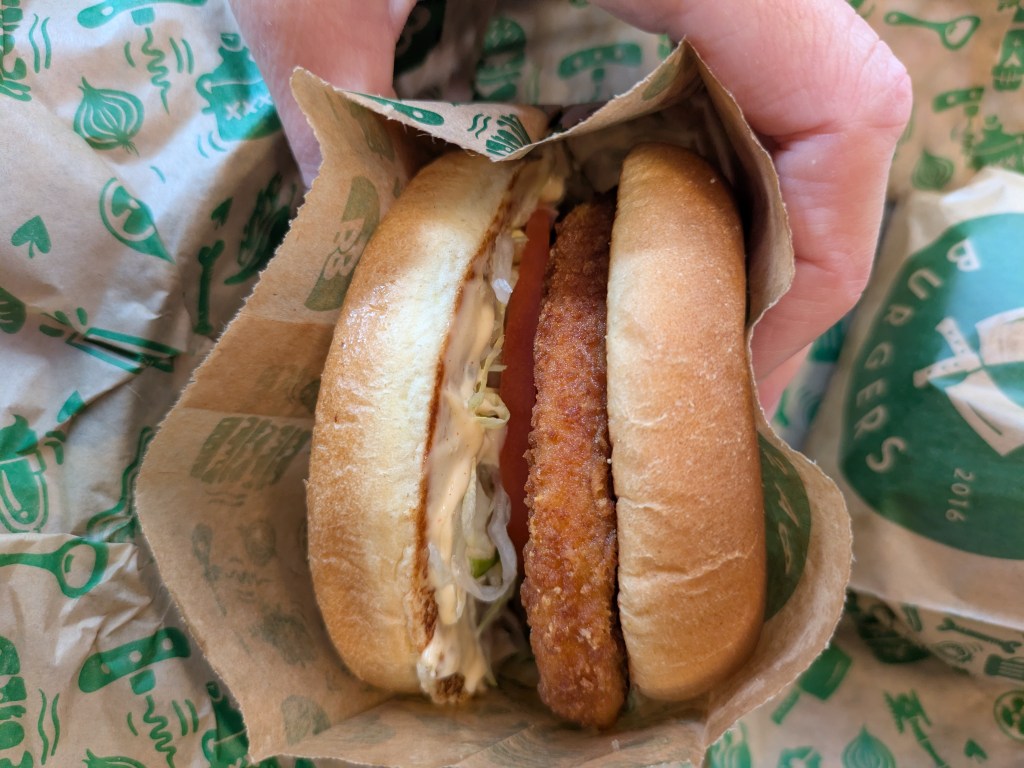 A chicken burger with a few simple garnishes