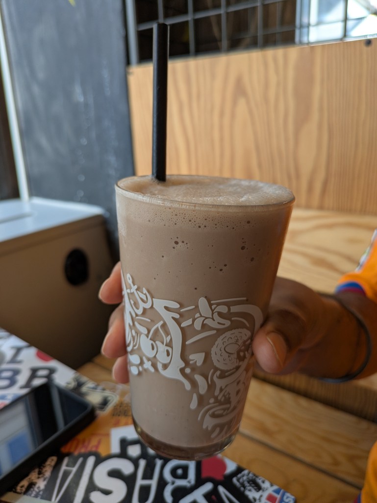 A big glass of chocolate milkshake 
