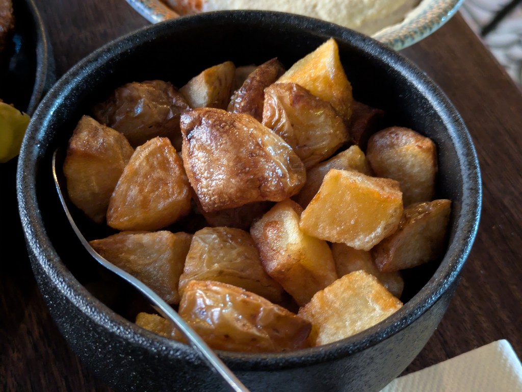 A bowl of fried potato chunks 